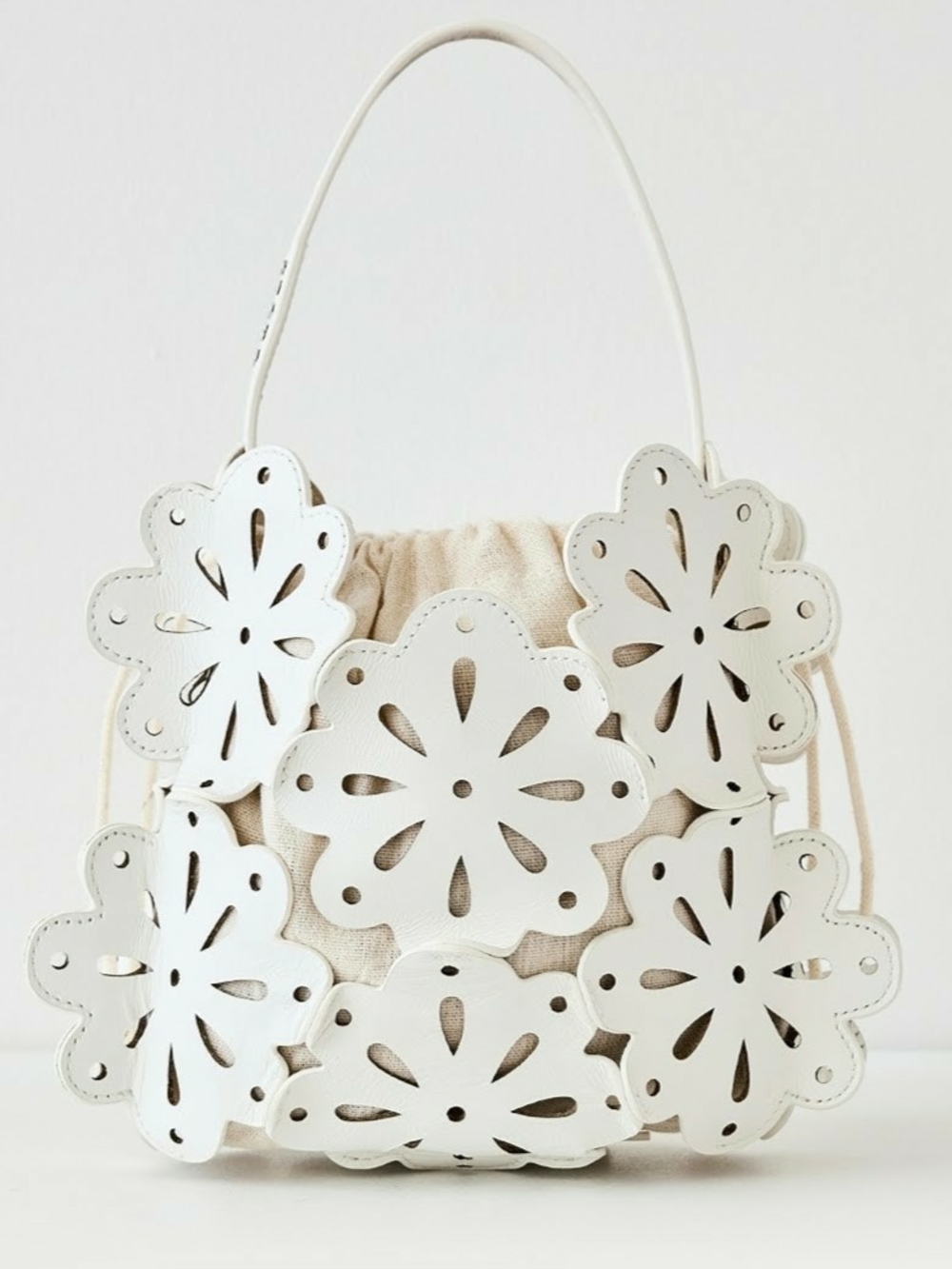STAUD White leather Floral Cutout Drawstring Top Handle Basket Bag